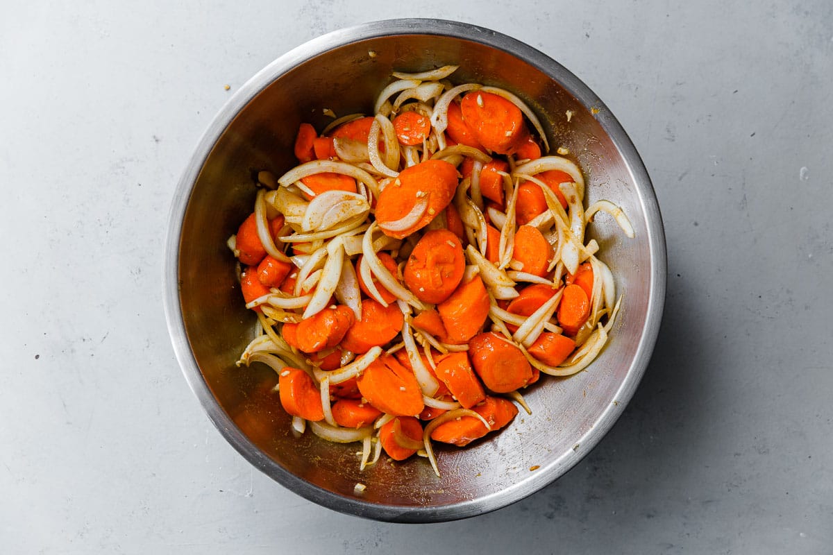 Sliced Carrots and Onions in Stainless Steel Bowl