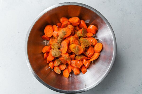 Sliced Carrots and Cumin in Stainless Steel Bowl