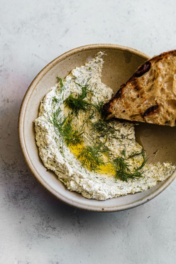 Garlic Dill Goat Cheese Spread in Bowl with Grilled Bead
