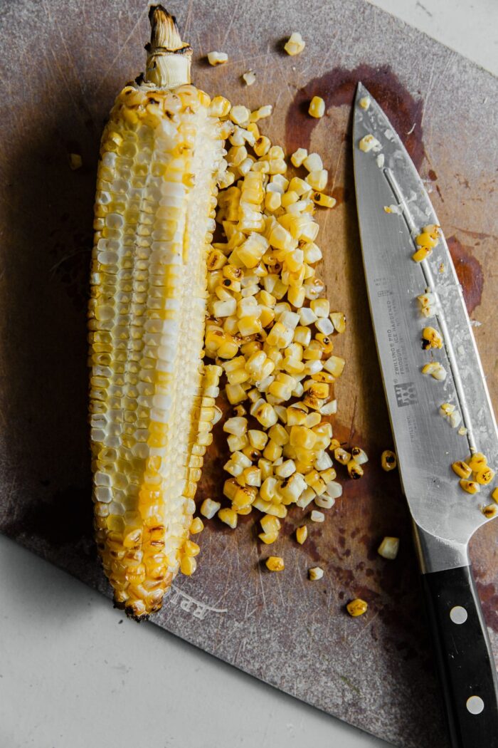 Grilled Corn Being Cut off Cob