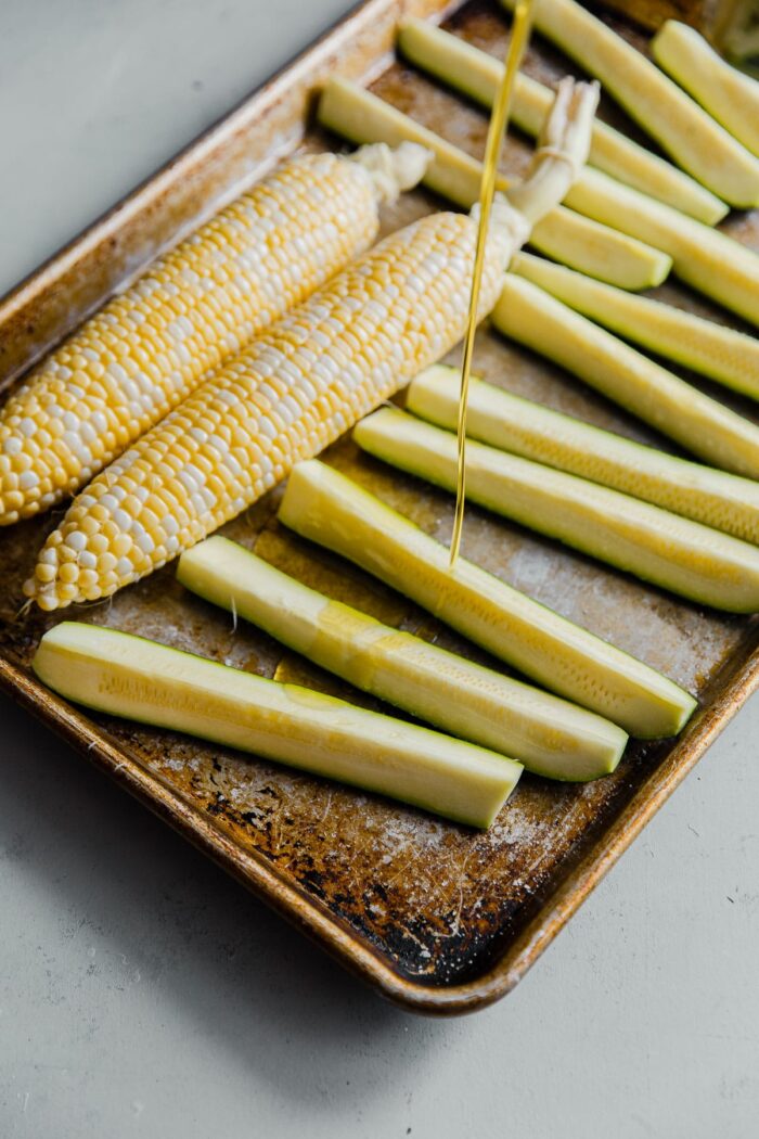 Drizzling Zucchini and Corn with Olive Oil