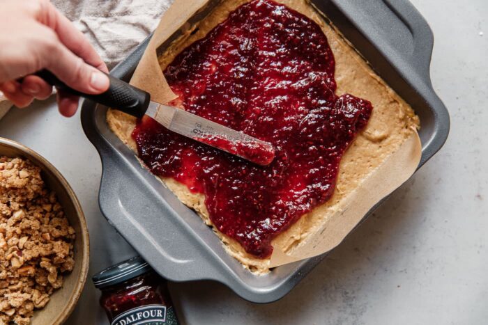 Spreading St.Dalfour Raspberry Fruit Spread on Batter