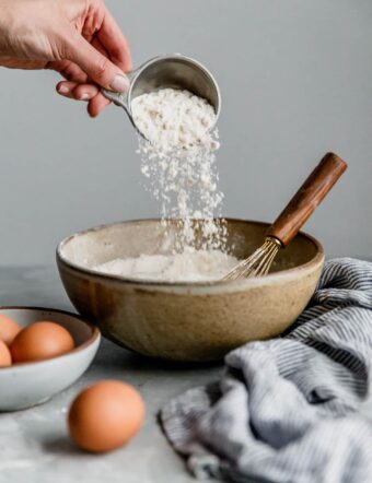 Pouring Flour from Measuring Cup into Bowl