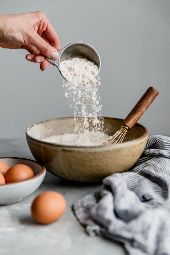 Pouring Flour from Measuring Cup into Bowl