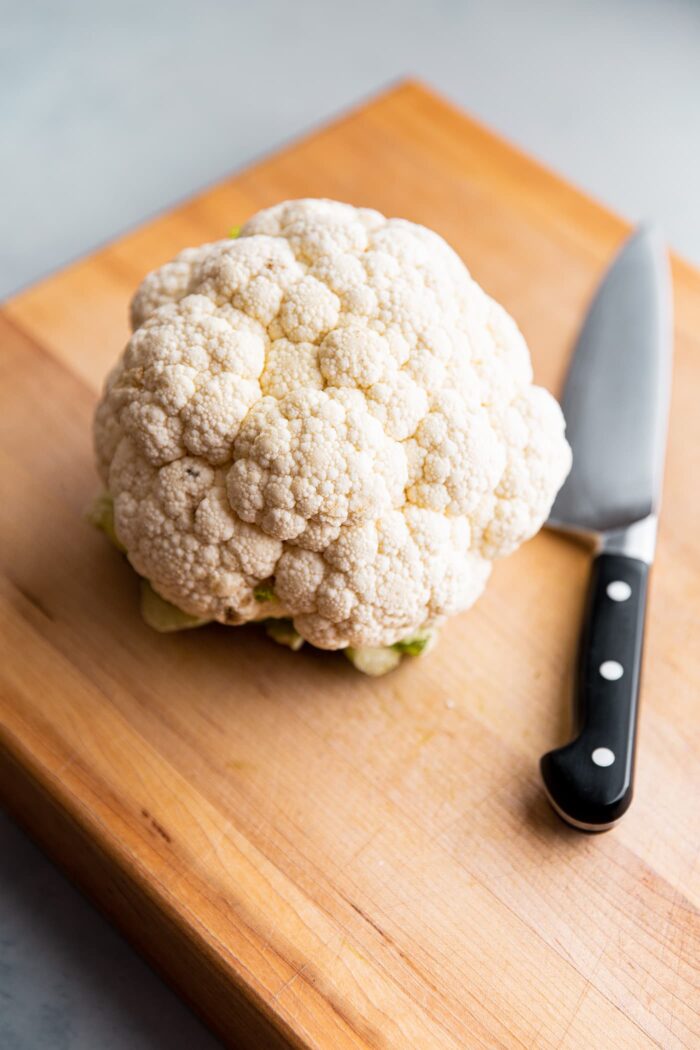 Whole Head of Cauliflower on Cutting Board