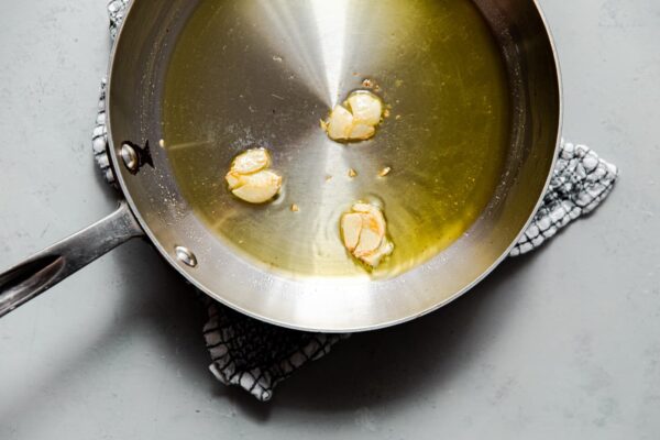 Smashed Garlic Cloves in Skillet with Olive Oil