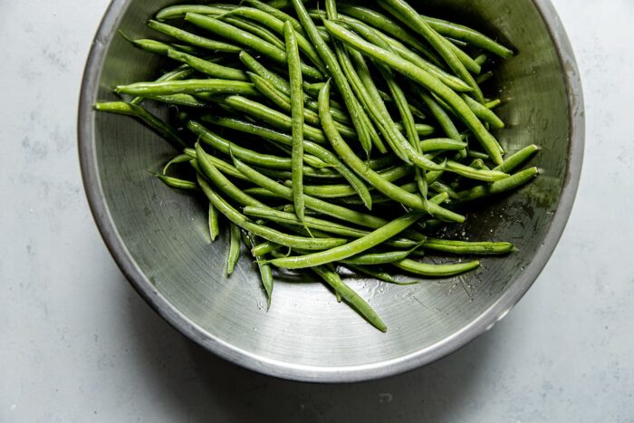 Green Beans Tossed with Olive oil in Bowl