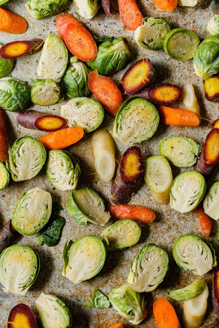 Brussels sprout halves and sliced Carrots on Sheet Pan