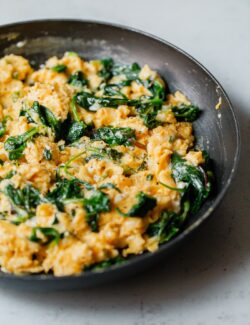 Cheesy Scrambled Eggs with Greens in Skillet