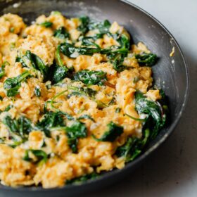 Cheesy Scrambled Eggs with Greens in Skillet