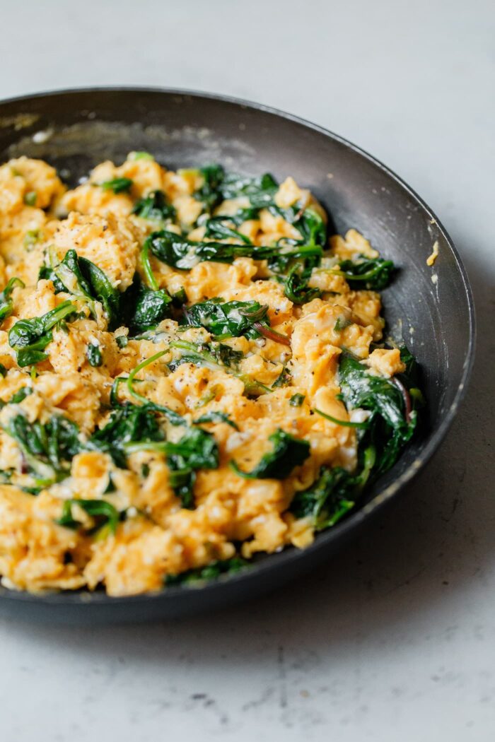 Cheesy Scrambled Eggs with Greens in Skillet