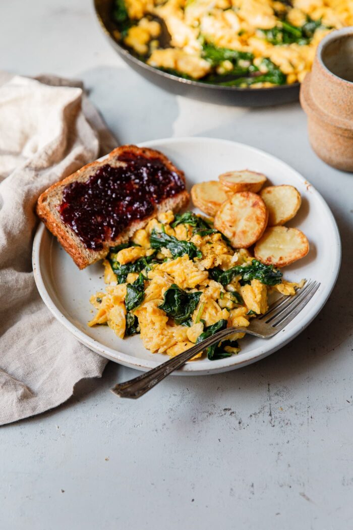 Cheesy Scrambled Eggs Breakfast Plate with Toast and Potatoes