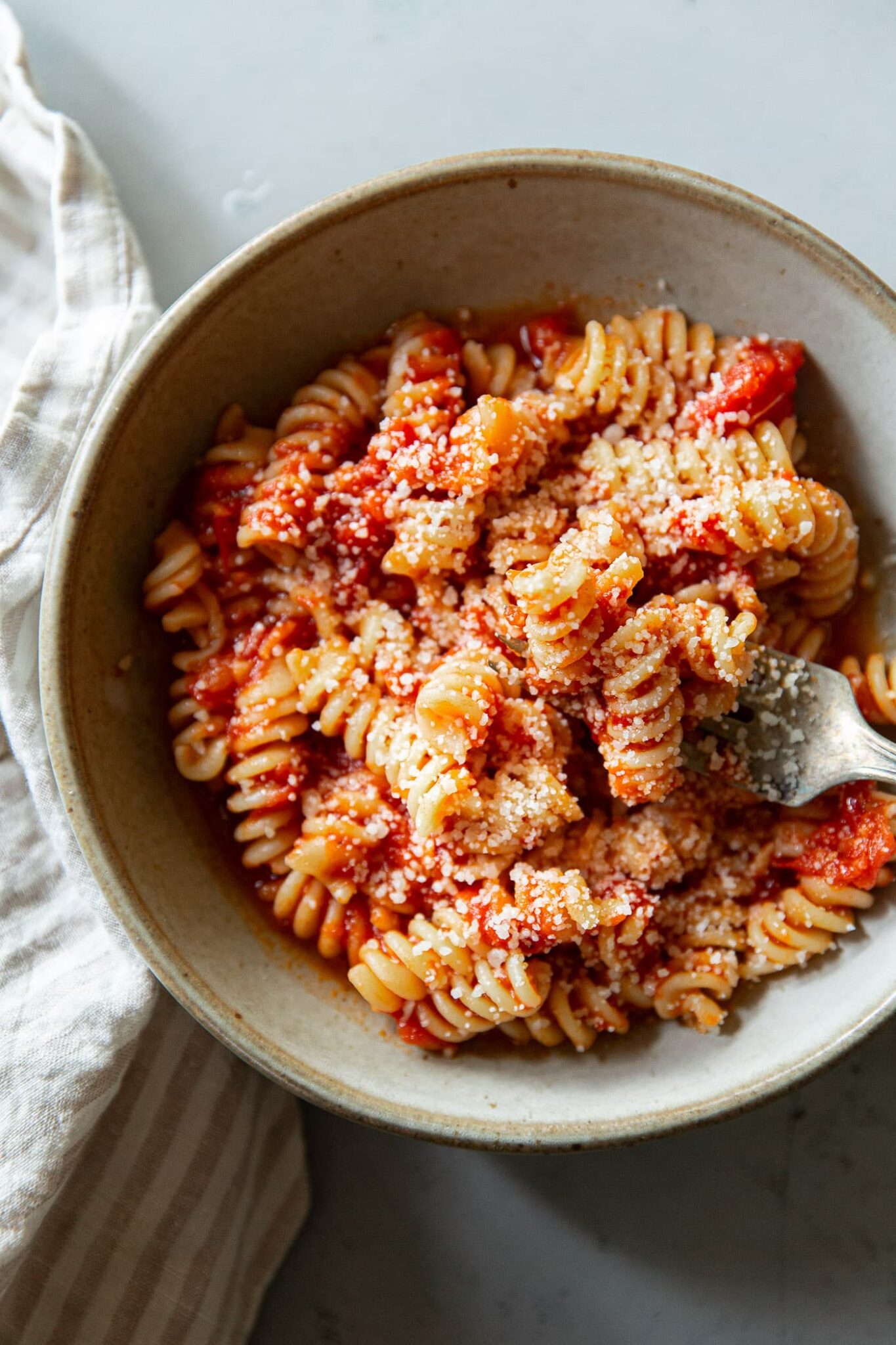 Tomato Pasta in Ceramic Bowl with Parmigiano Reggiano Cheese
